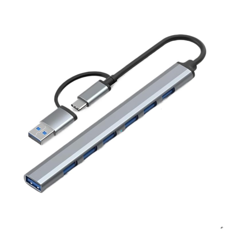 Un hub USB-C a USB con siete puertos USB 3.0 y cuerpo de aluminio gris muestra su cable corto y conectores para ampliar la conexión del equipo.
