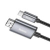 Cable Hoco UA27 USB-C a HDMI de 2 metros, con recubrimiento trenzado negro y conectores de aluminio para transmitir video 4K a 30 Hz.